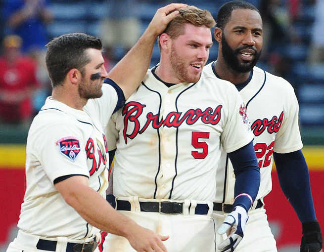 A walk-off hit by Freddie Freeman (center) on Sunday gave Atlanta its 12th win in 15 games.
